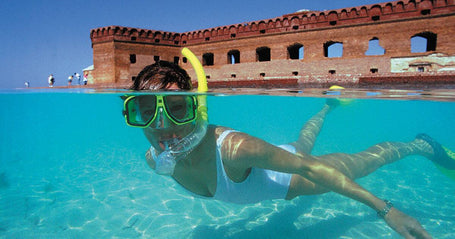 Snorkeler with a building in the back
