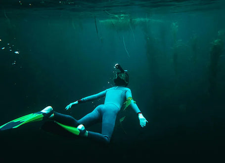 Snorkeler with kelp in the distance