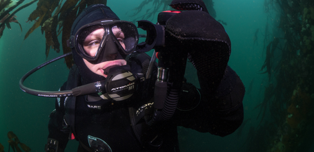 Diver holding up their integrated octo